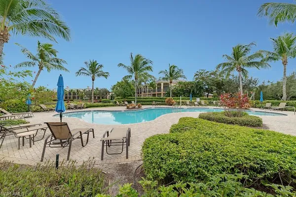a view of a garden with flowers and trees