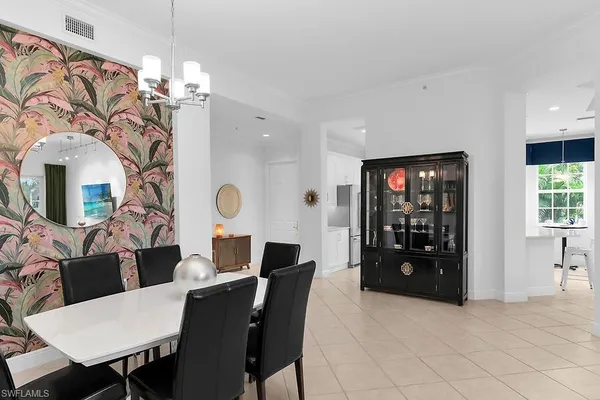 a view of a dining room with furniture and chandelier