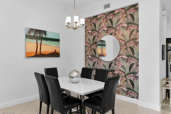 a view of a dining room with furniture and chandelier