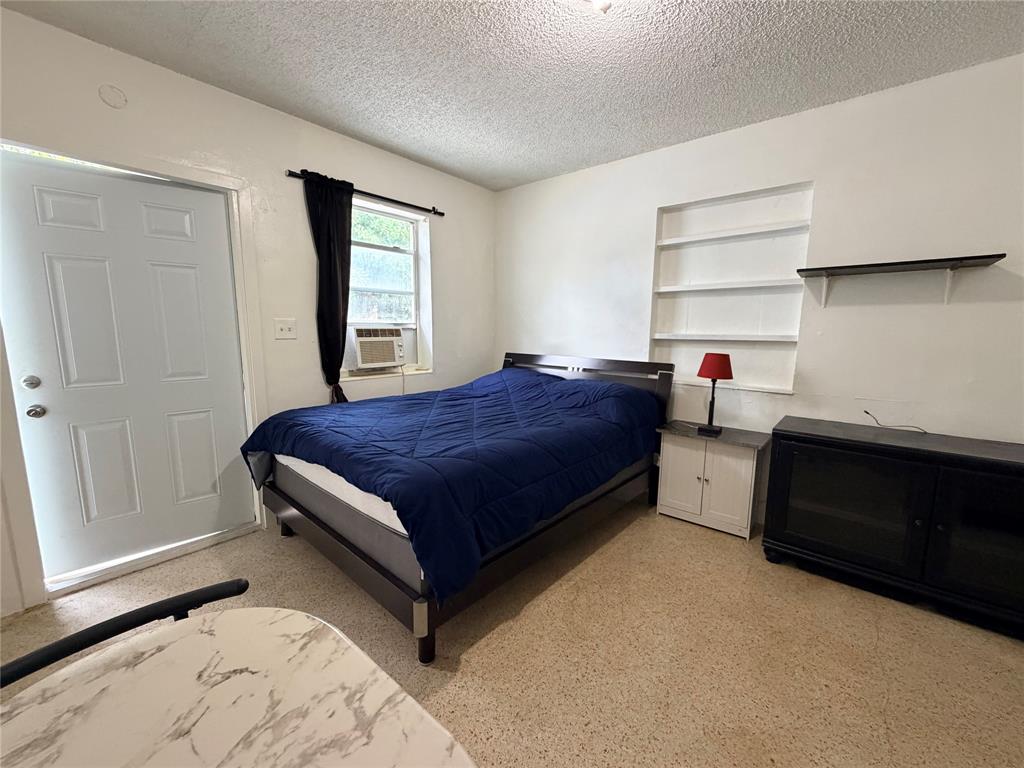 1822 Cleveland Street, Unit 1REAR Hollywood, FL 33020 - Photo 4 of 6 a bedroom with a bed and a window