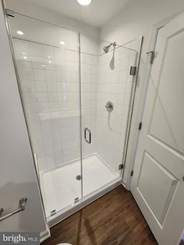 a bathroom with a glass door shower and toilet