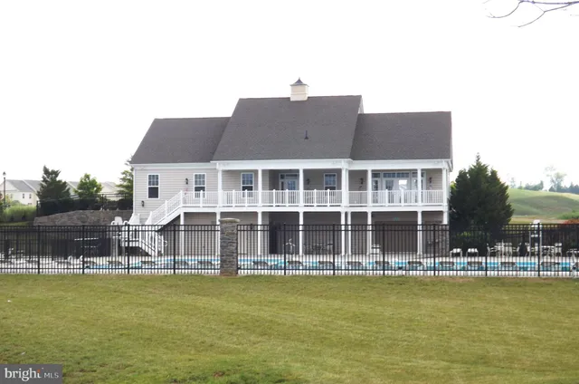 a view of a house with a yard from a lake