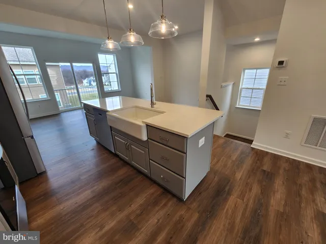 a view of a room with wooden floor and staircase