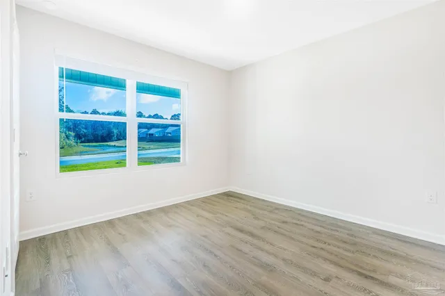 a kitchen with granite countertop a sink and a stove top oven with wooden floor