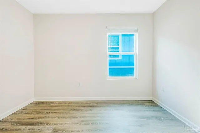 a view of a kitchen with a sink and wooden floor