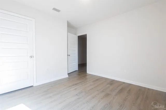 a view of a kitchen with a sink and wooden floor