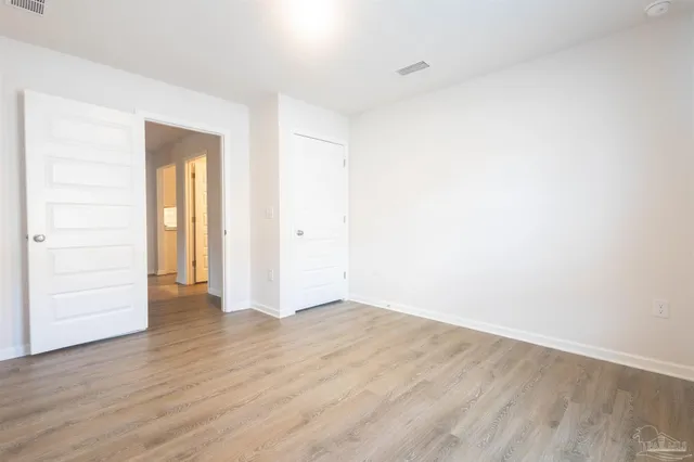 a view of a house with swimming pool next to a yard