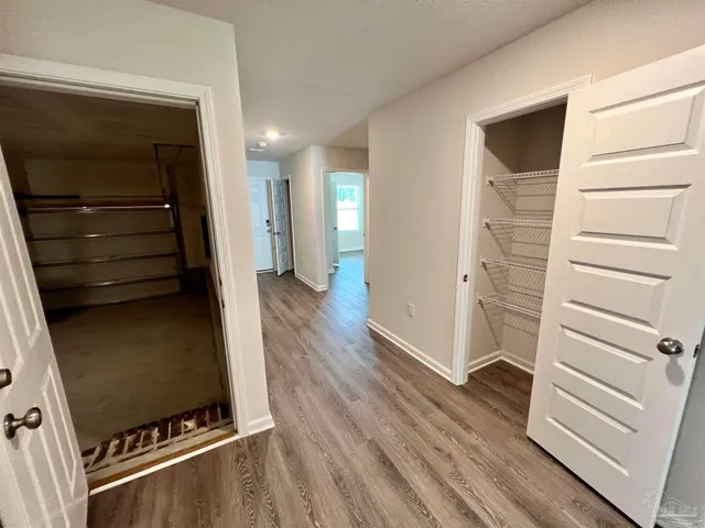 a view of walk in closet with empty racks
