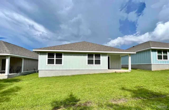 a front view of house with yard and green space