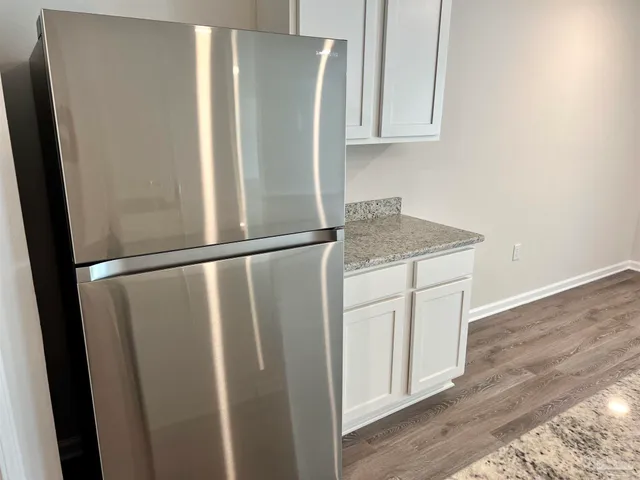 a kitchen with a refrigerator and a sink