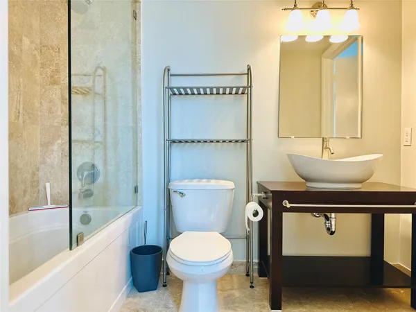 a bathroom with a sink toilet and shower