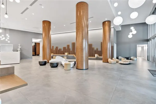 a view of a lobby with a floor to ceiling window and stairs