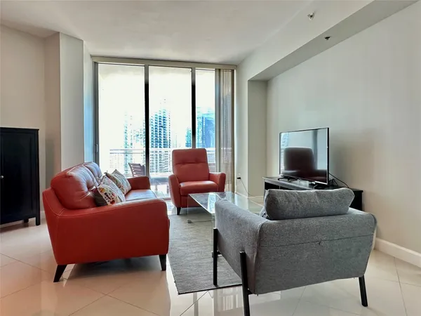 a living room with furniture and a flat screen tv