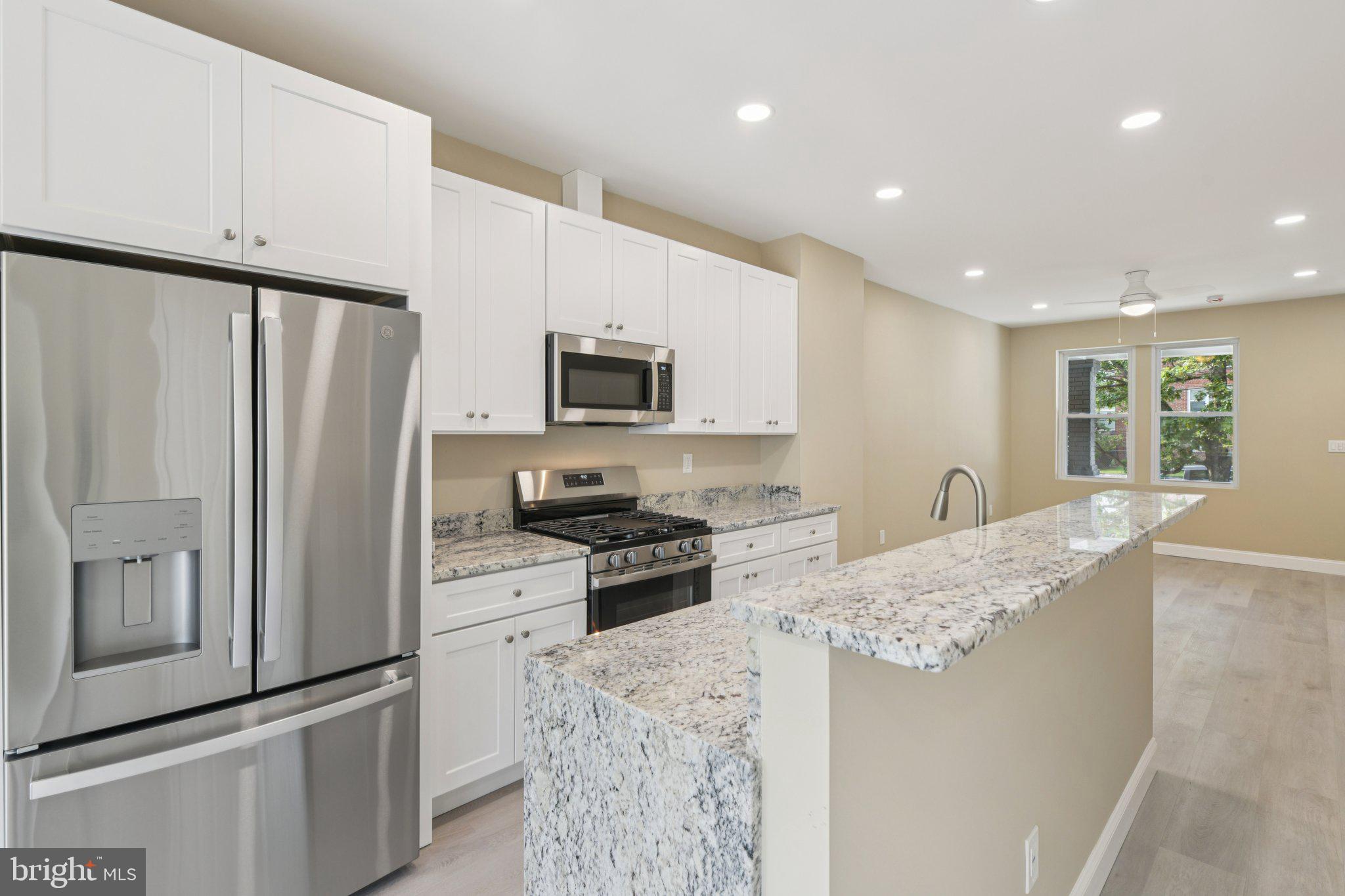 729 Madison Street Northwest Washington, DC 20011 - Photo 12 of 59 a kitchen with stainless steel appliances granite countertop a refrigerator stove microwave and sink
