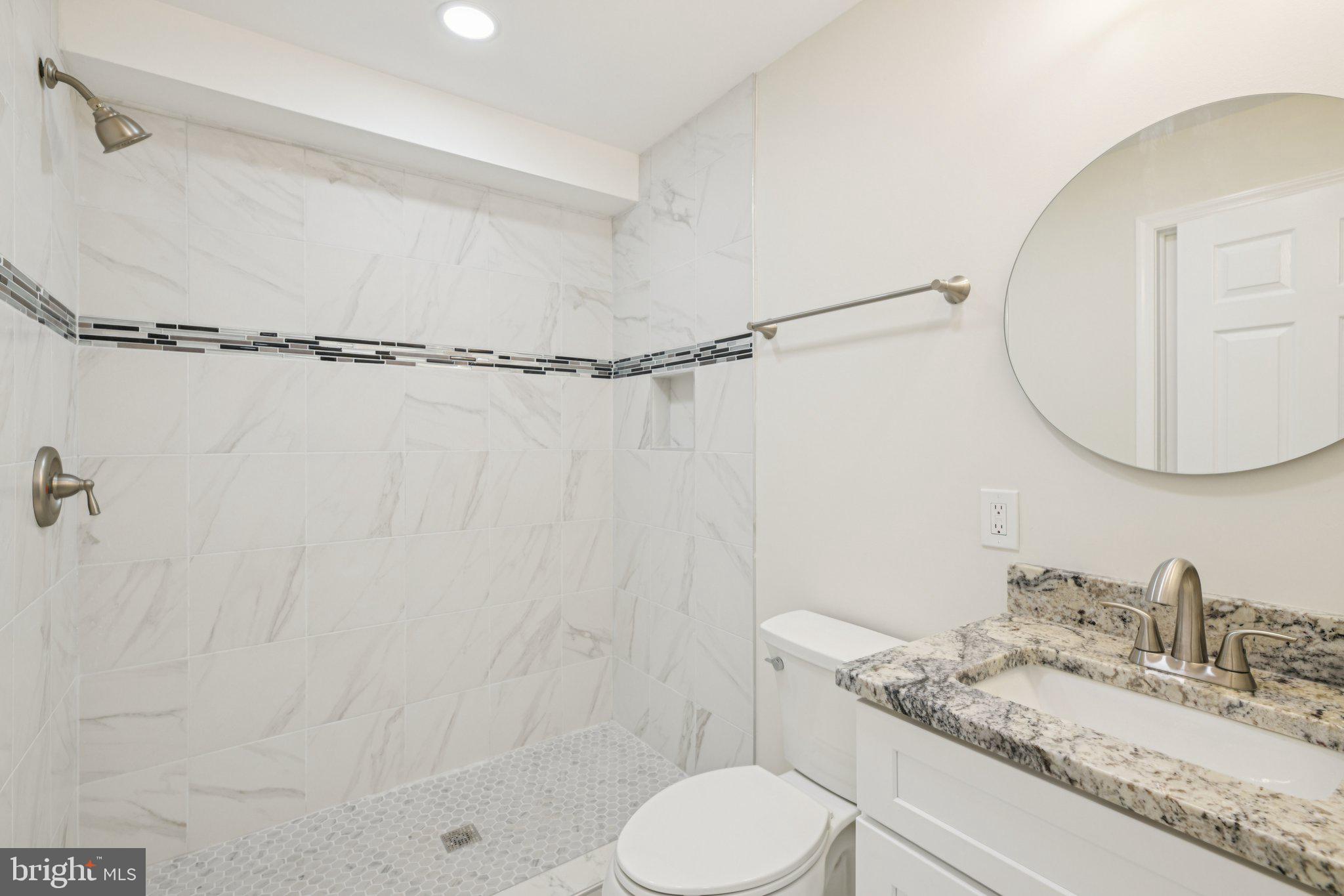 729 Madison Street Northwest Washington, DC 20011 - Photo 43 of 59 a bathroom with a granite countertop sink toilet and shower