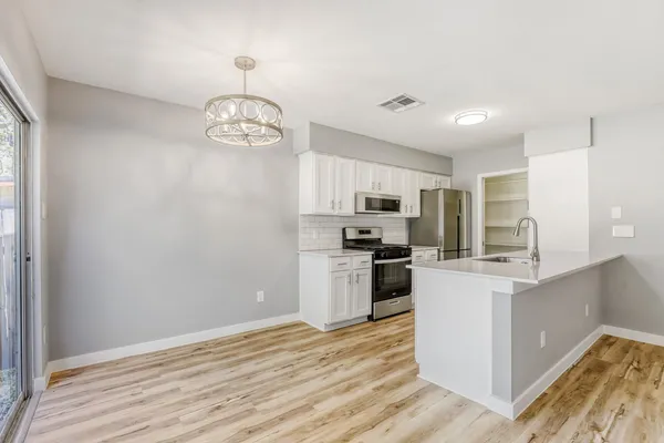 a kitchen that has a sink and a stove