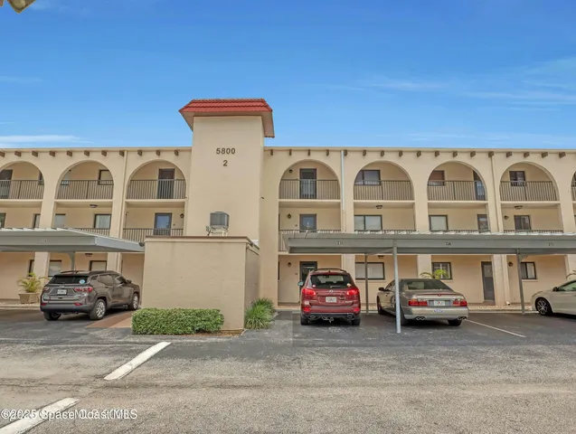 a front view of a building with parking space