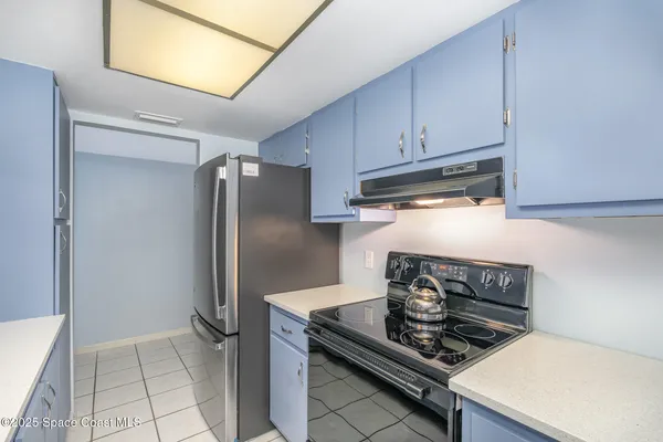 a kitchen with stainless steel appliances granite countertop a stove and a refrigerator
