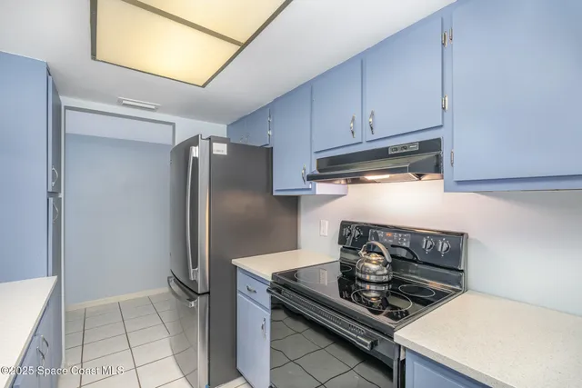 a kitchen with stainless steel appliances granite countertop a stove and a refrigerator
