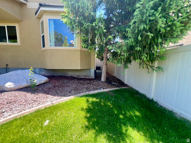 369 Culross Circle Tooele, UT 84074 - Photo 44 of 54 Expansive lawn area with a defined border, featuring a mature evergreen tree