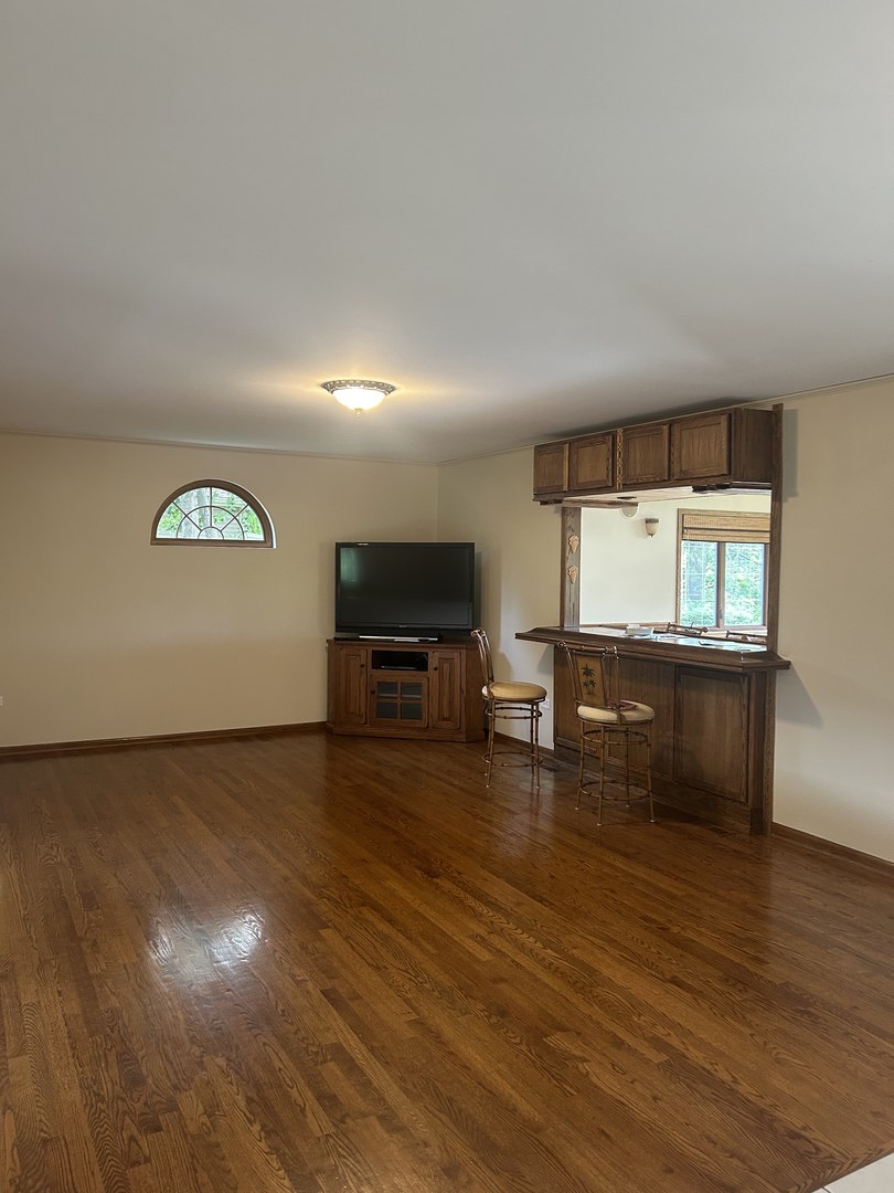 527 Springwood Lane Bolingbrook, IL 60440 - Photo 11 of 35 a view of a livingroom with furniture hardwood floor and workspace