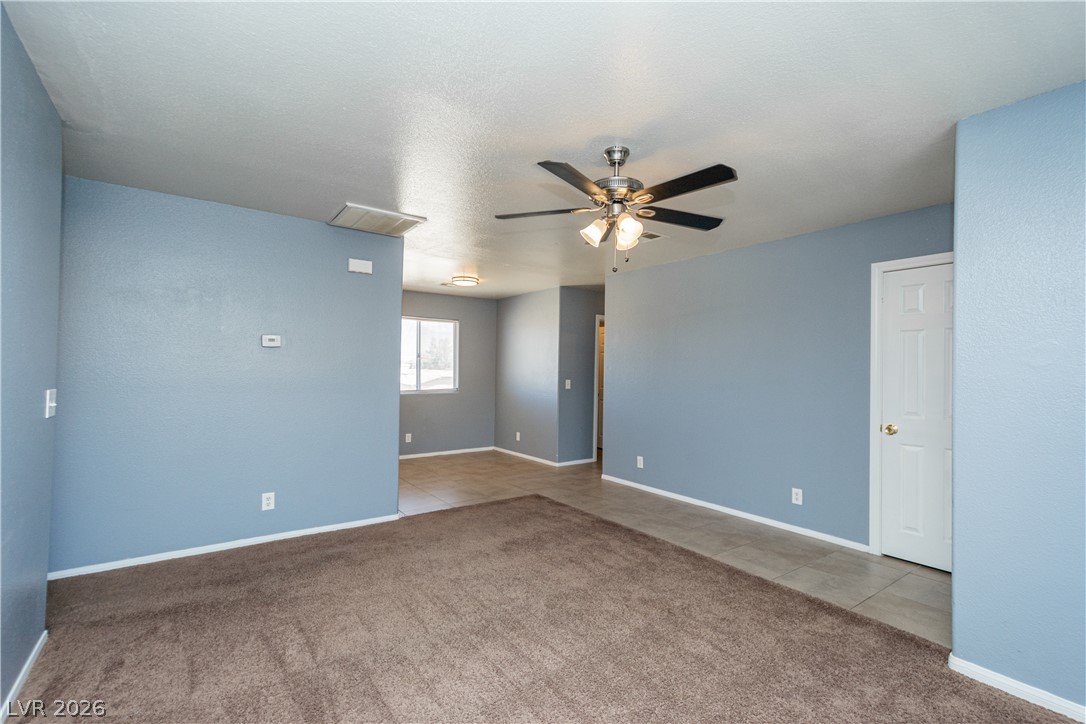 1444 Star Road Pahrump, NV 89048 - Photo 37 of 37 An open floor plan connects the carpeted living space to an adjacent tiled dining area.