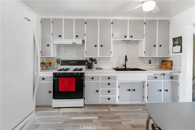 a kitchen with stainless steel appliances cabinets a stove and a window