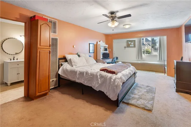 a bedroom with a bed dresser and a window