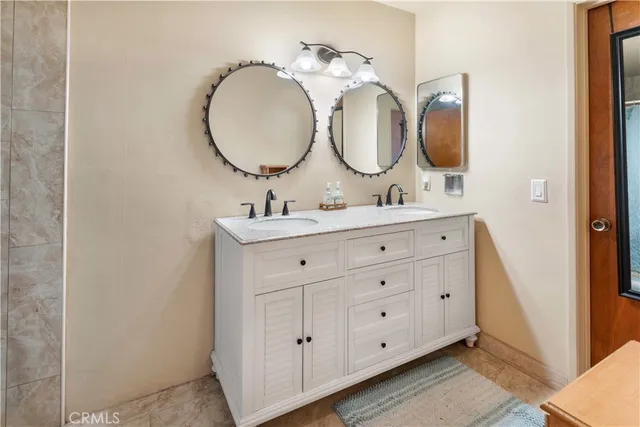 a bathroom with a double vanity sink and a mirror