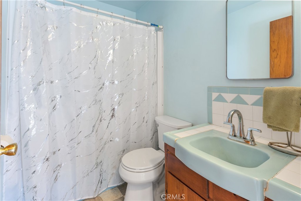 766 South 6th Street Grover Beach, CA 93433 - Photo 8 of 20 a bathroom with a sink toilet and mirror