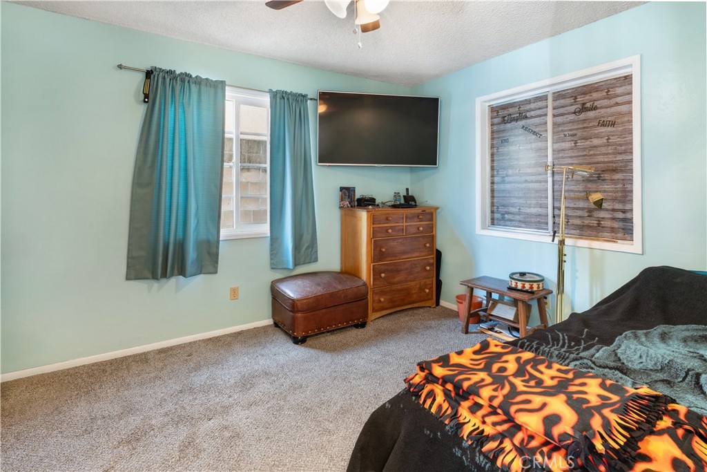 766 South 6th Street Grover Beach, CA 93433 - Photo 9 of 20 a bedroom with furniture and a flat screen tv