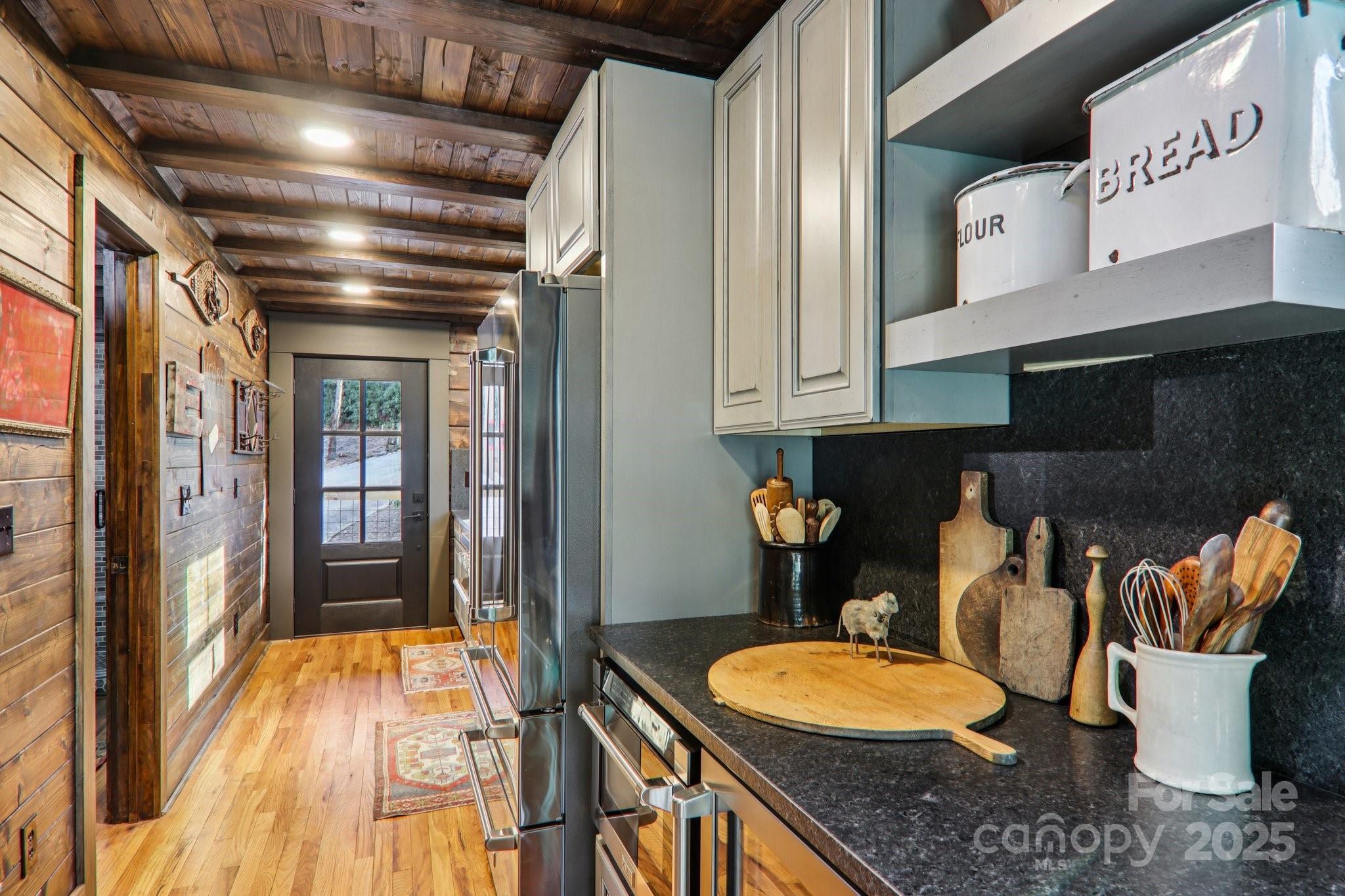 408 Little Elbow Mountain Road Lake Toxaway, NC 28747 - Photo 15 of 48 a bathroom with a granite countertop toilet a mirror and bathtub