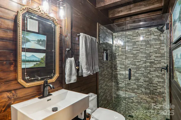 a bathroom with a sink toilet and shower