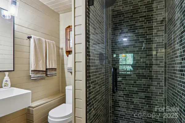 a bathroom with a shower toilet and sink