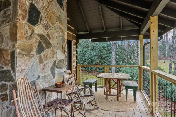 a patio with glass top table and chairs