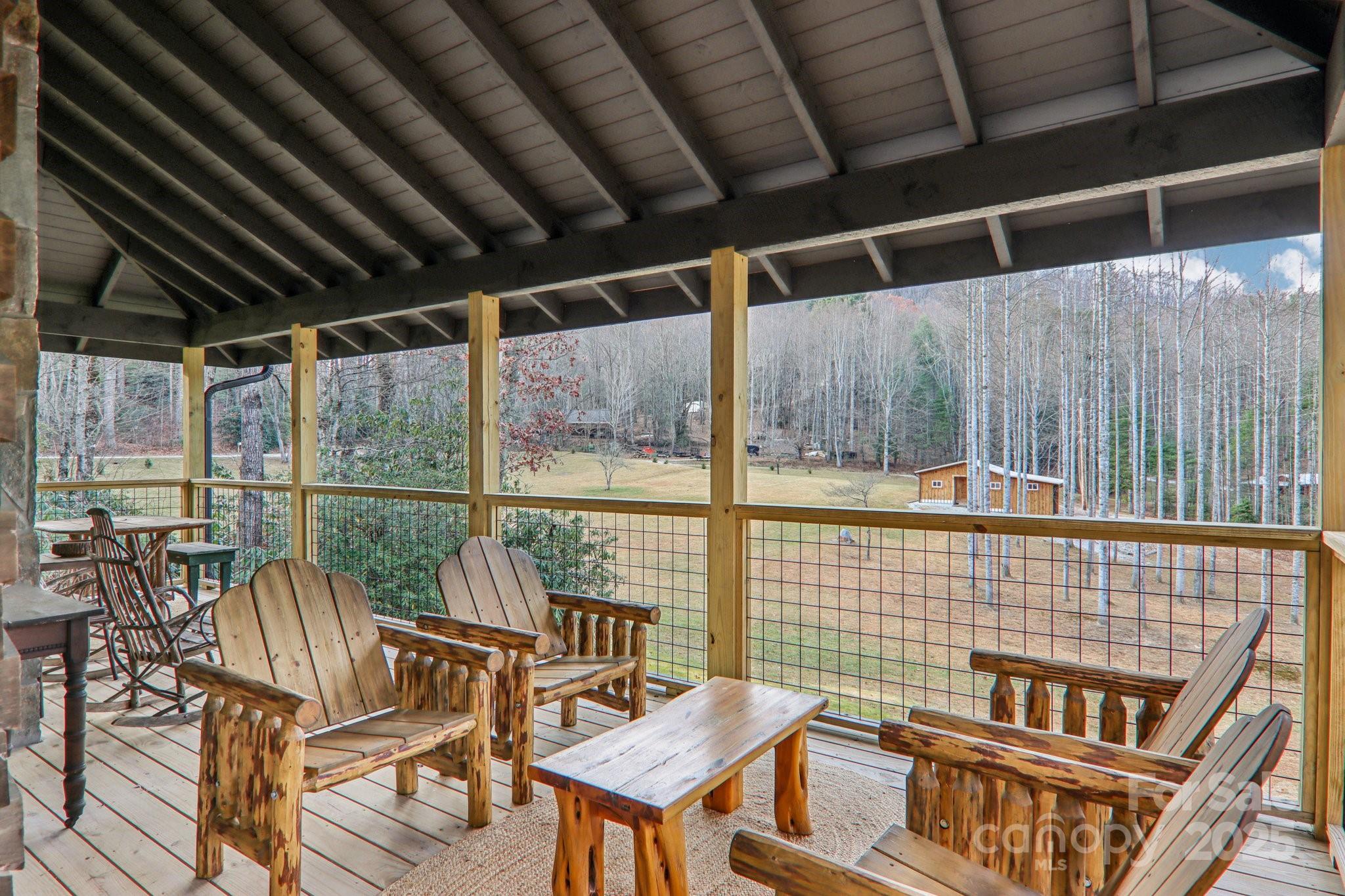 408 Little Elbow Mountain Road Lake Toxaway, NC 28747 - Photo 28 of 48 a roof deck with table and chairs