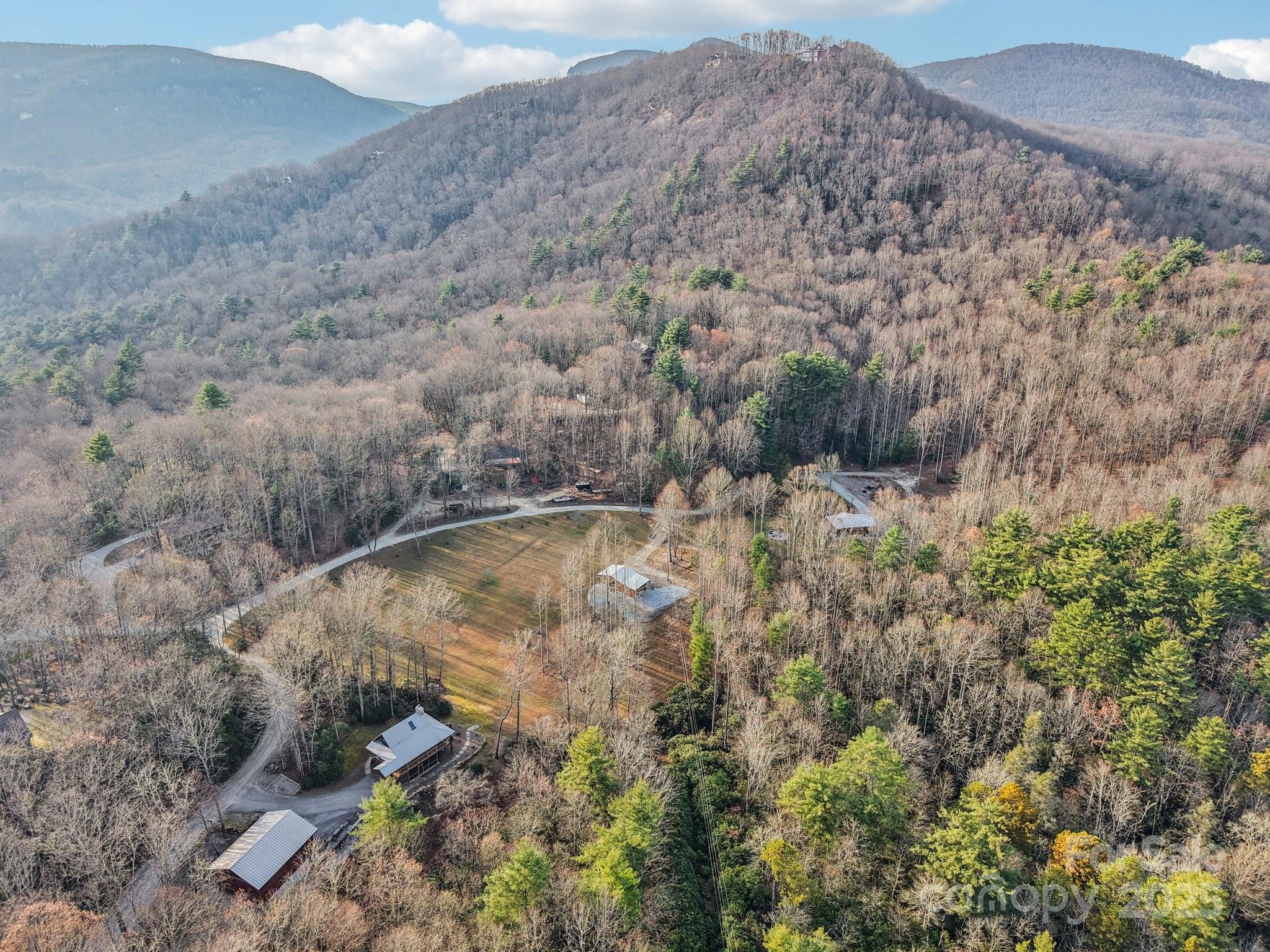 408 Little Elbow Mountain Road Lake Toxaway, NC 28747 - Photo 3 of 48 a view of a dry field with trees in the background