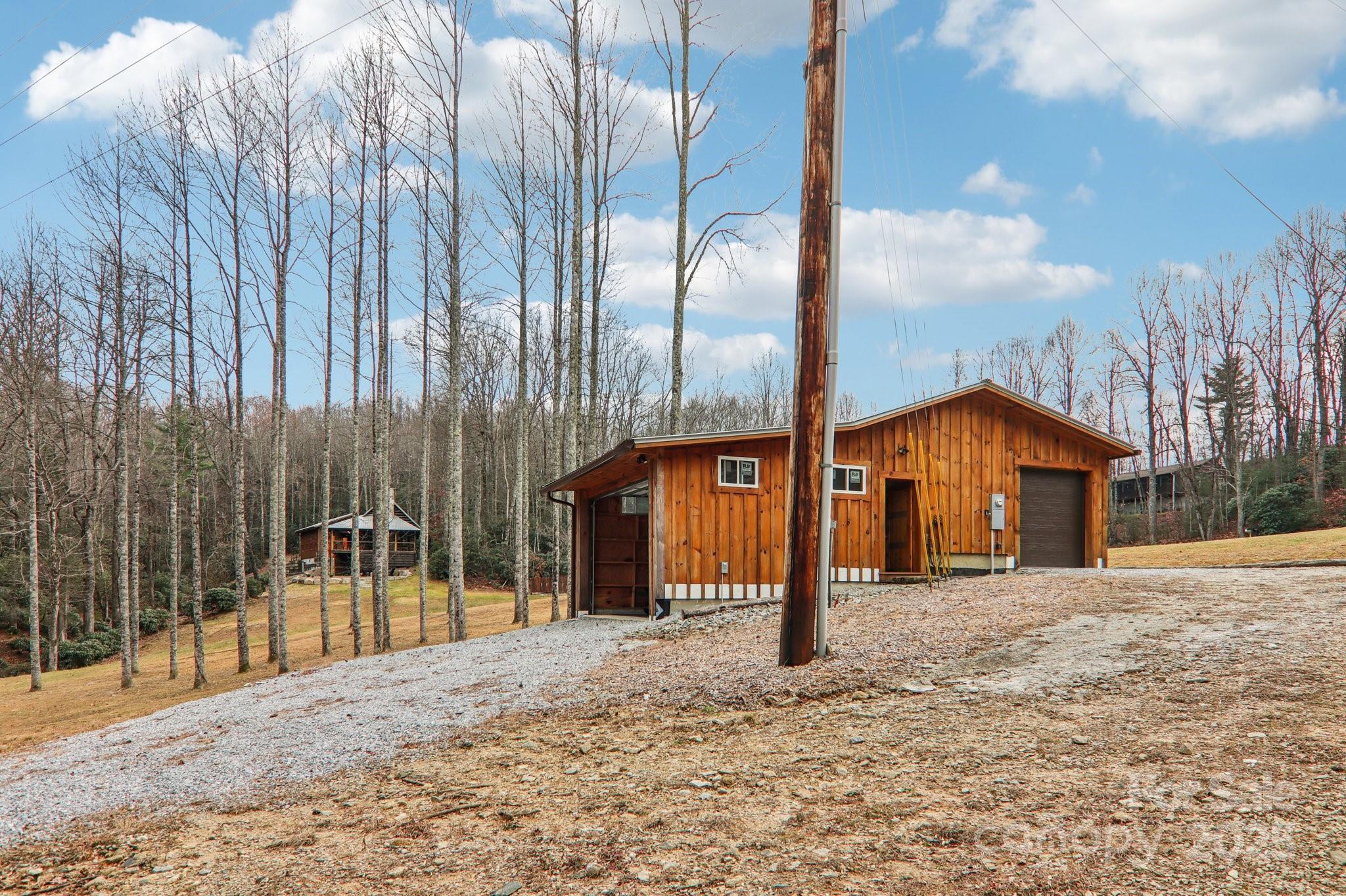 408 Little Elbow Mountain Road Lake Toxaway, NC 28747 - Photo 34 of 48 a front view of a building with a garden
