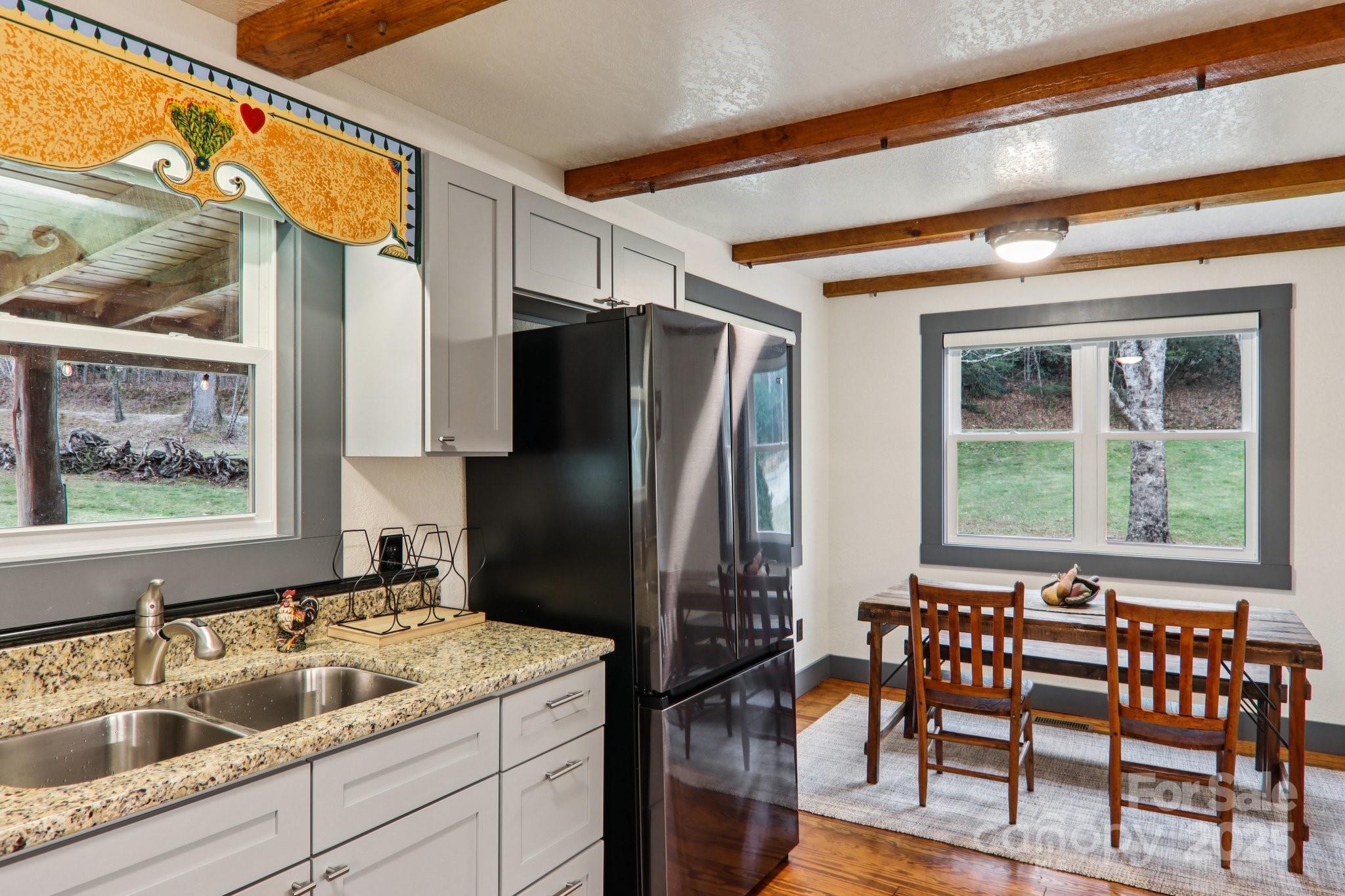 408 Little Elbow Mountain Road Lake Toxaway, NC 28747 - Photo 42 of 48 a kitchen with a refrigerator and a sink
