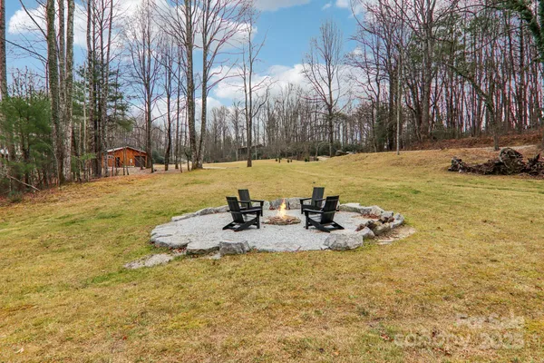 a backyard of a house with table and chairs