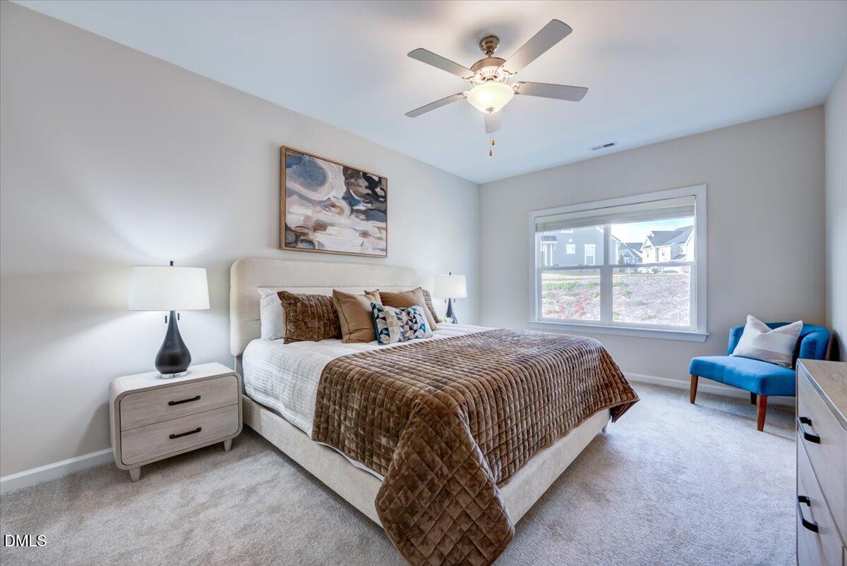 1209 Alston Ridge Cary, NC 27519 - Photo 12 of 27 a bedroom with a bed a couch and a large window