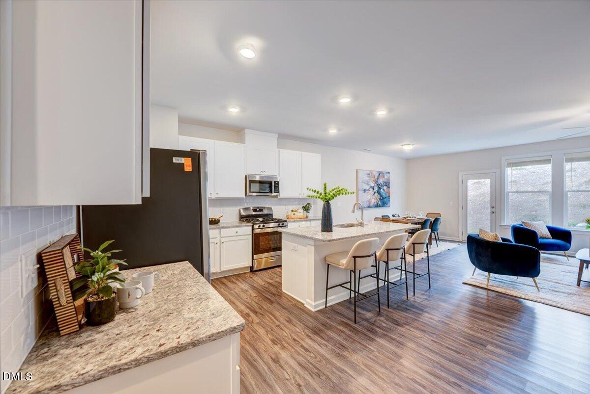 1209 Alston Ridge Cary, NC 27519 - Photo 5 of 27 a kitchen with a dining table chairs and view living room