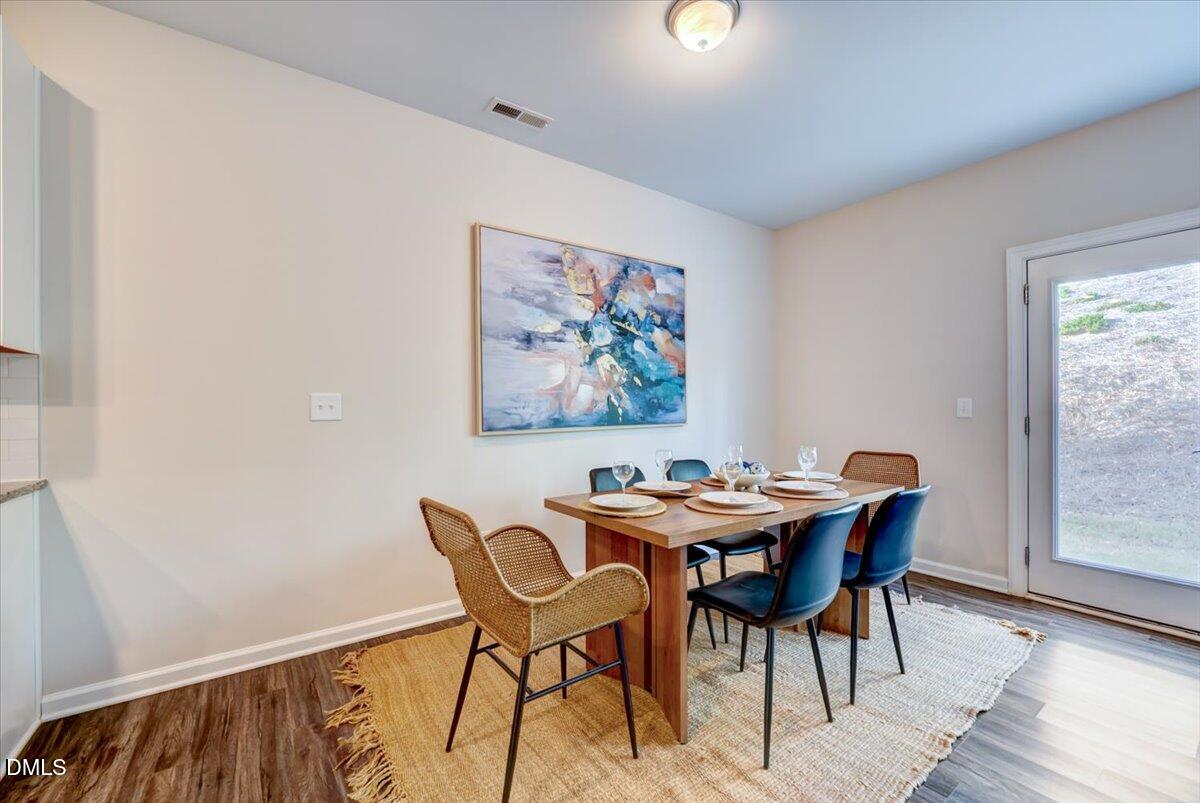 1209 Alston Ridge Cary, NC 27519 - Photo 7 of 27 a view of a dining room with furniture and wooden floor