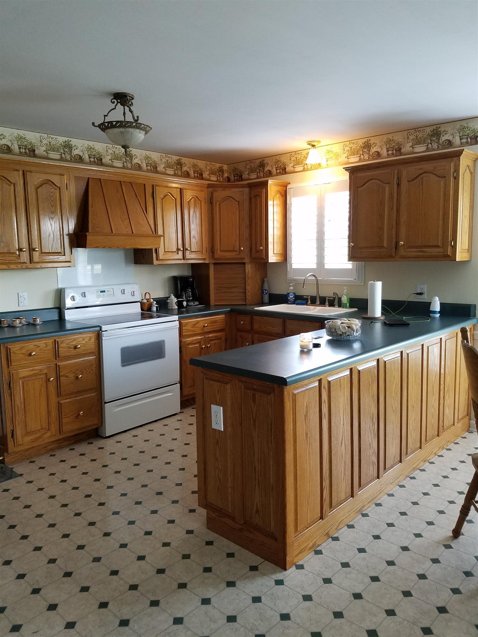 4026 Powers Bridge Road Manchester, TN 37355 - Photo 2 of 3 a kitchen with a sink stove and cabinets