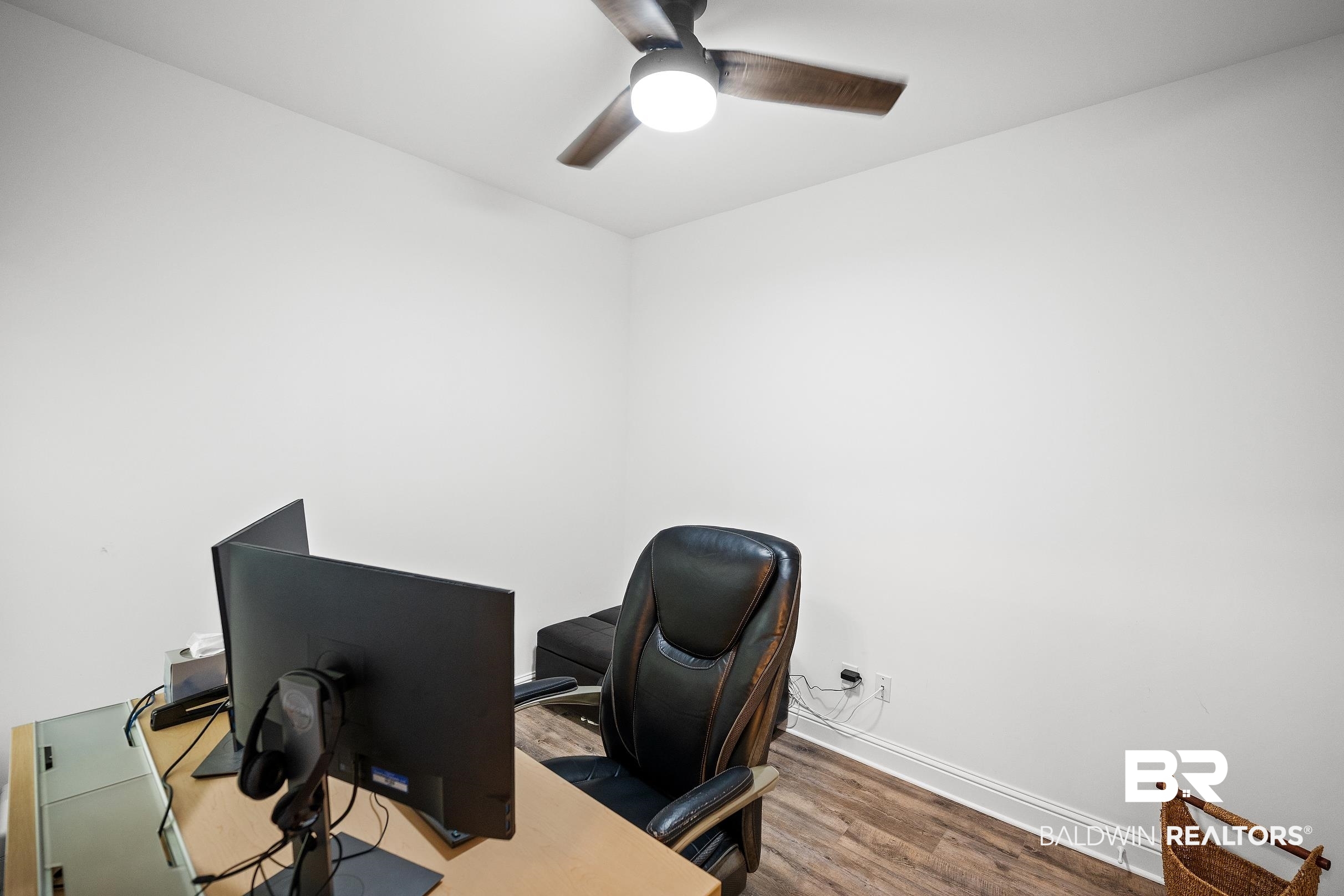 2651 South Juniper Street, Unit 2002 Foley, AL 36535 - Photo 15 of 23 Room featuring wood-finish flooring, white baseboards, and neutral wall paint