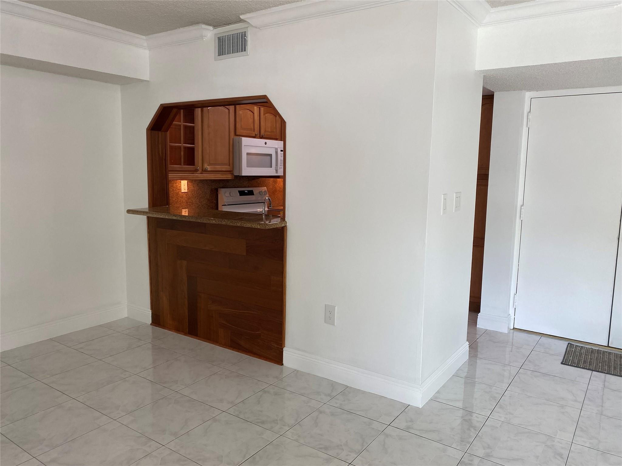 11790 Southwest 18th Street, Unit 106 Miami, FL 33175 - Photo 18 of 23 an empty room with mirror and door