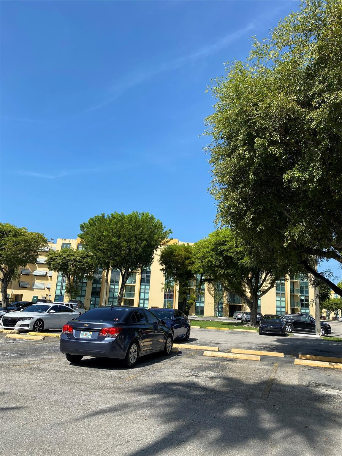 11790 Southwest 18th Street, Unit 106 Miami, FL 33175 - Photo 2 of 23 a view of street with parked cars