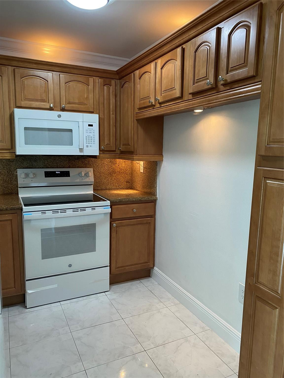 11790 Southwest 18th Street, Unit 106 Miami, FL 33175 - Photo 21 of 23 a kitchen with stainless steel appliances granite countertop a stove a sink and a refrigerator