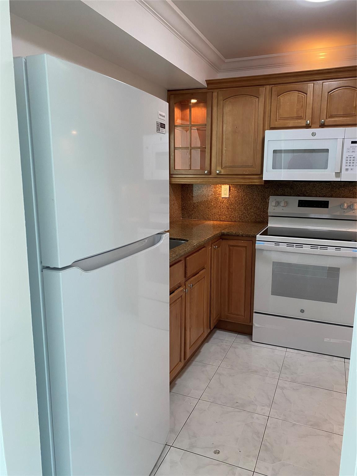 11790 Southwest 18th Street, Unit 106 Miami, FL 33175 - Photo 22 of 23 a kitchen with stainless steel appliances granite countertop a refrigerator and a stove top oven