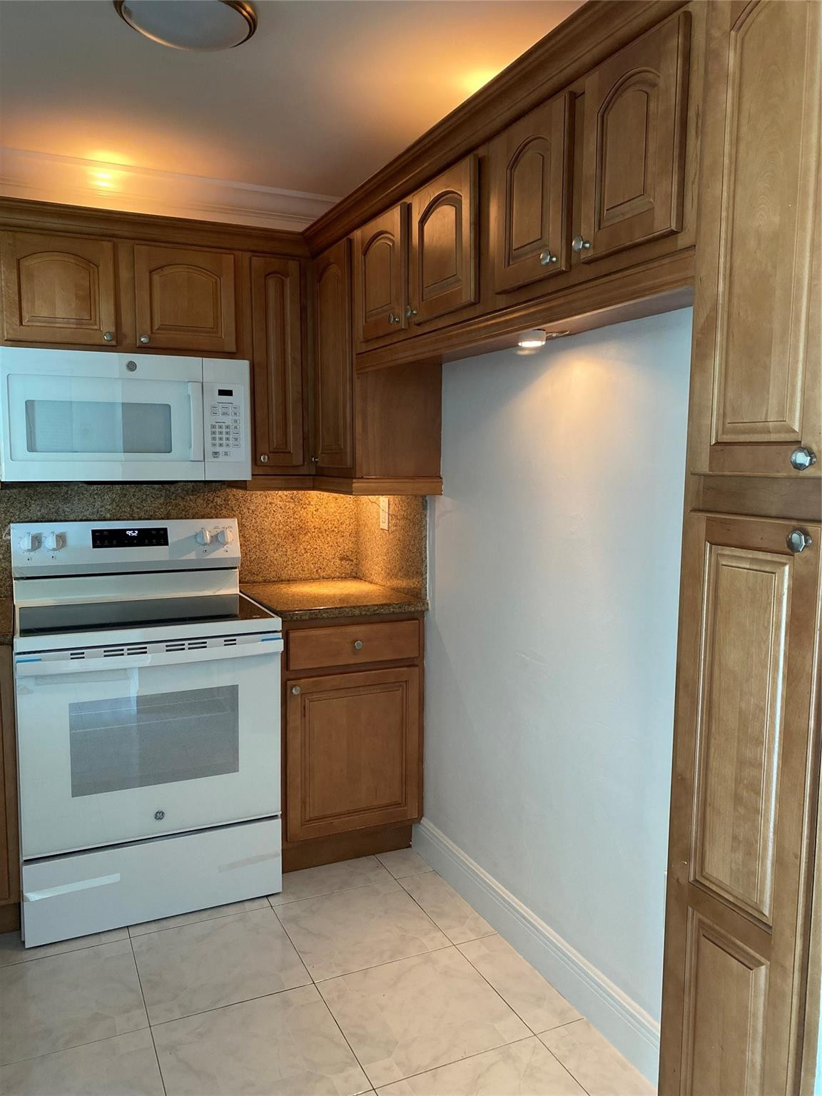 11790 Southwest 18th Street, Unit 106 Miami, FL 33175 - Photo 3 of 23 a kitchen with stainless steel appliances granite countertop a refrigerator and a stove